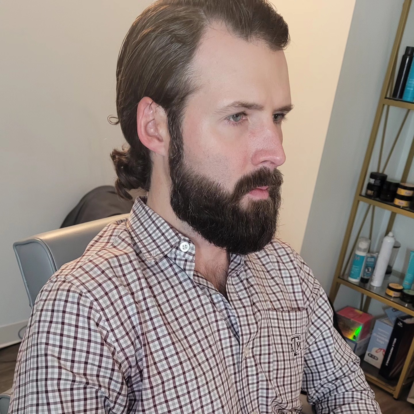 Long hair tied back with beard